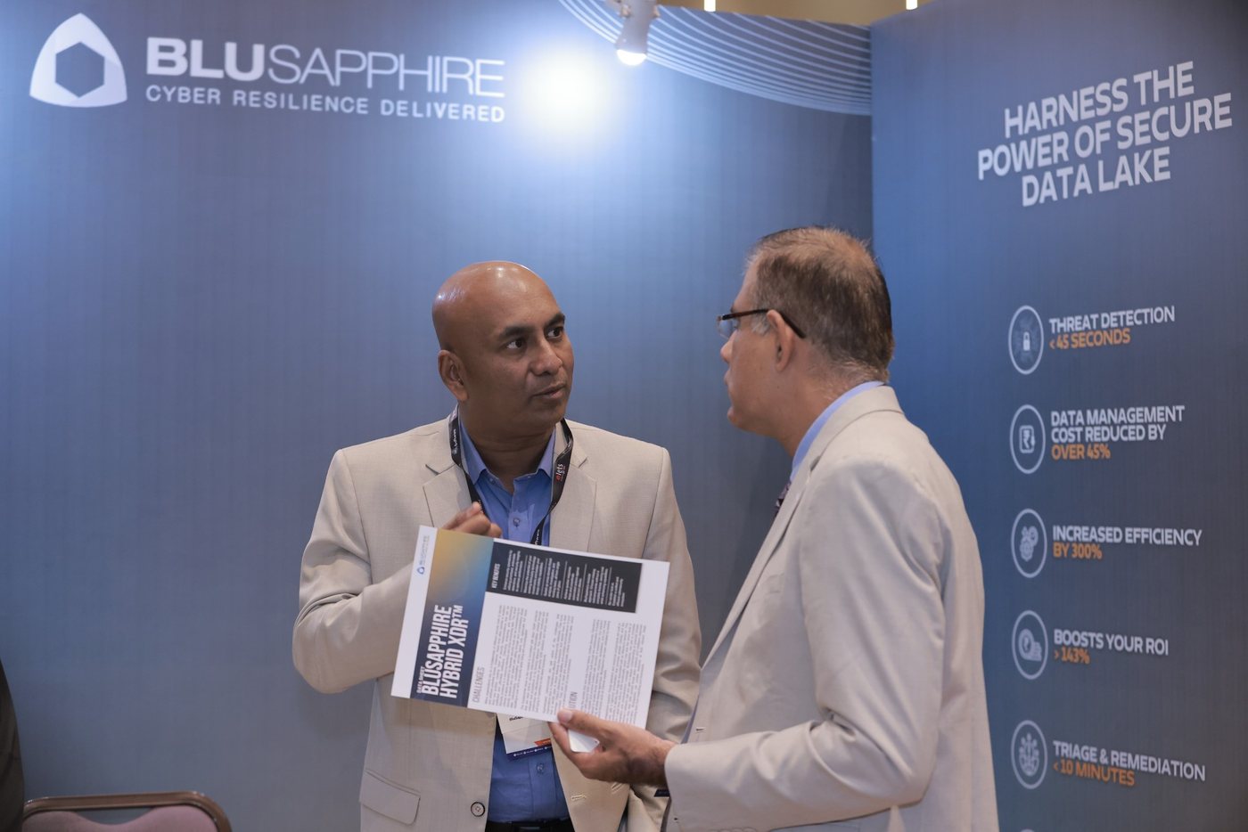 Delegates discussing AI solutions on the summit exhibition floor