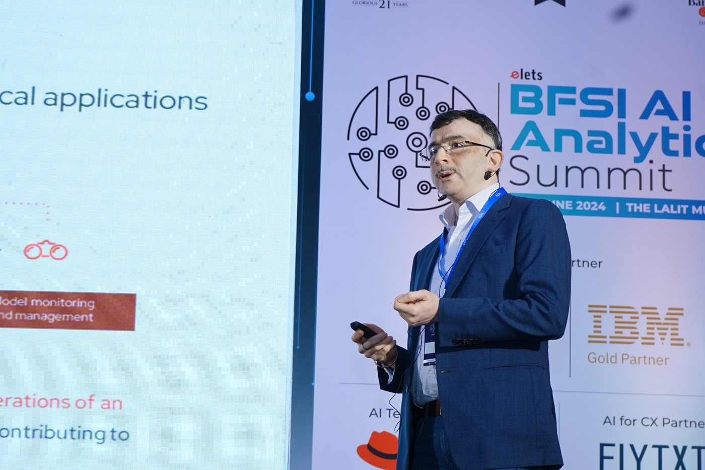 Speaker presenting an AI case study to the summit audience