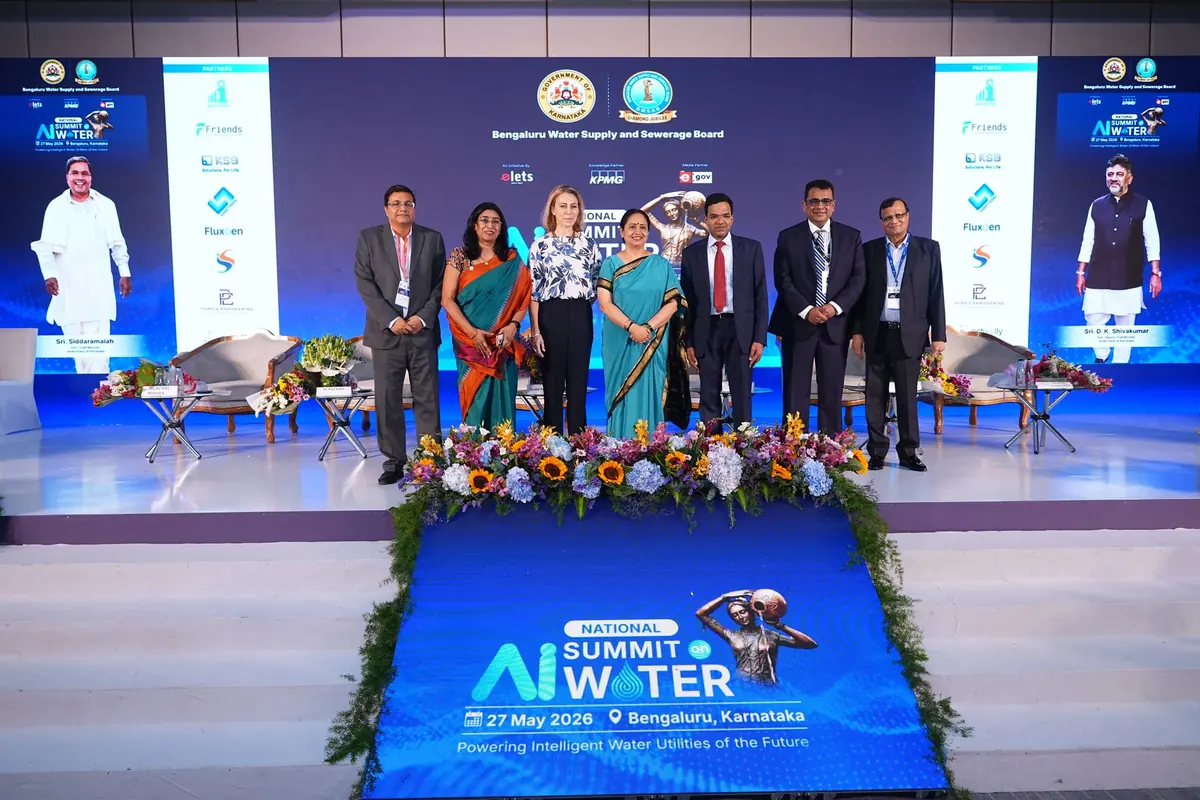Dignitaries standing on stage in front of the summit backdrop