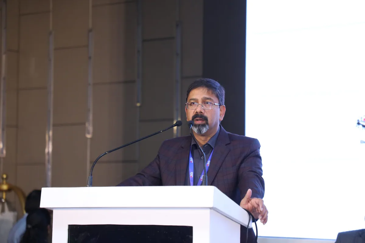 A speaker addressing the audience from the podium