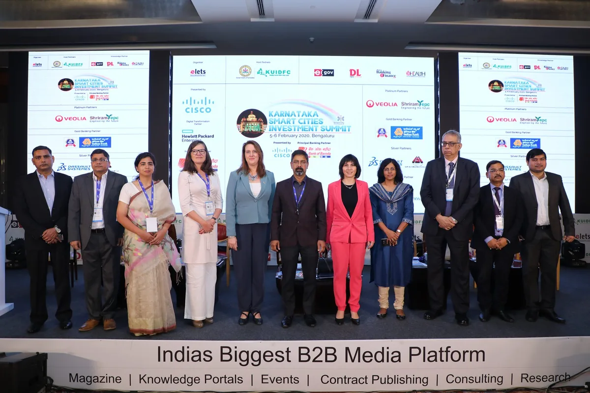 Group photograph of delegates on stage before the partner backdrop