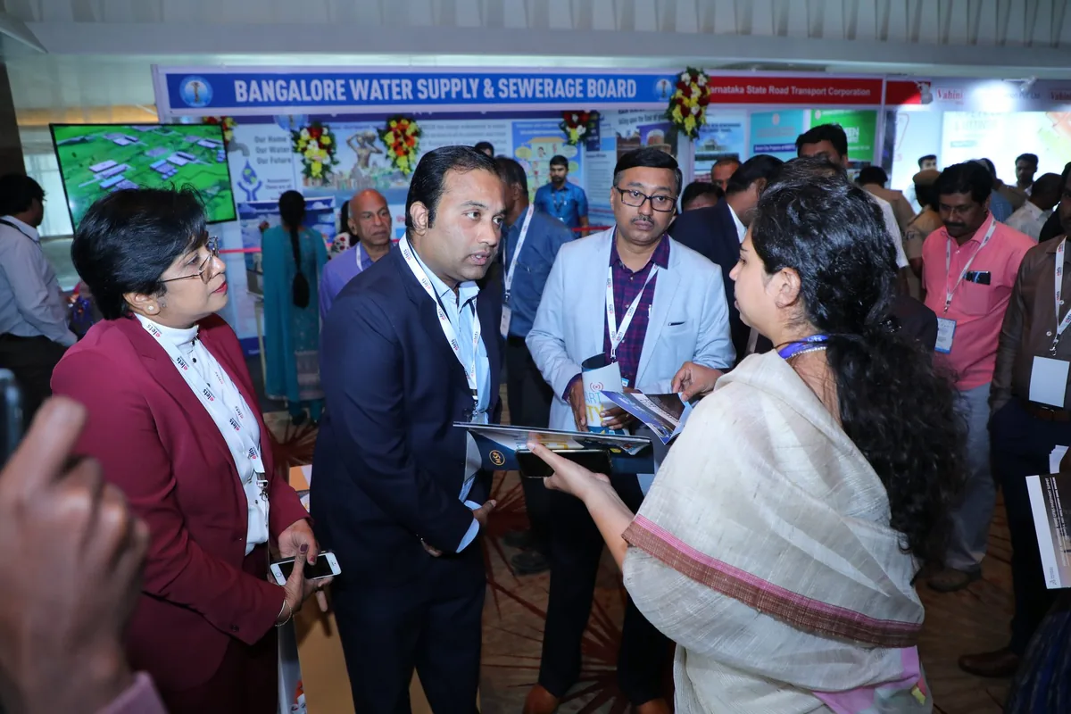 Delegates in conversation at an exhibition stand