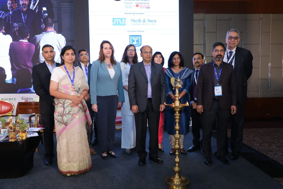 Group photograph beside the lit ceremonial lamp