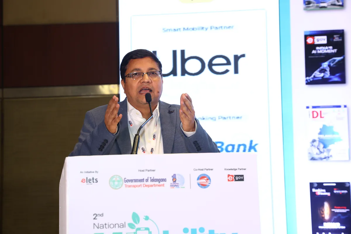 A speaker addresses delegates from the National Mobility Summit podium
